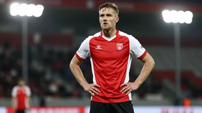 A photorealistic image of an anonymous Sarpsborg 08 player in his 20s, wearing a red and white jersey with a smooth...